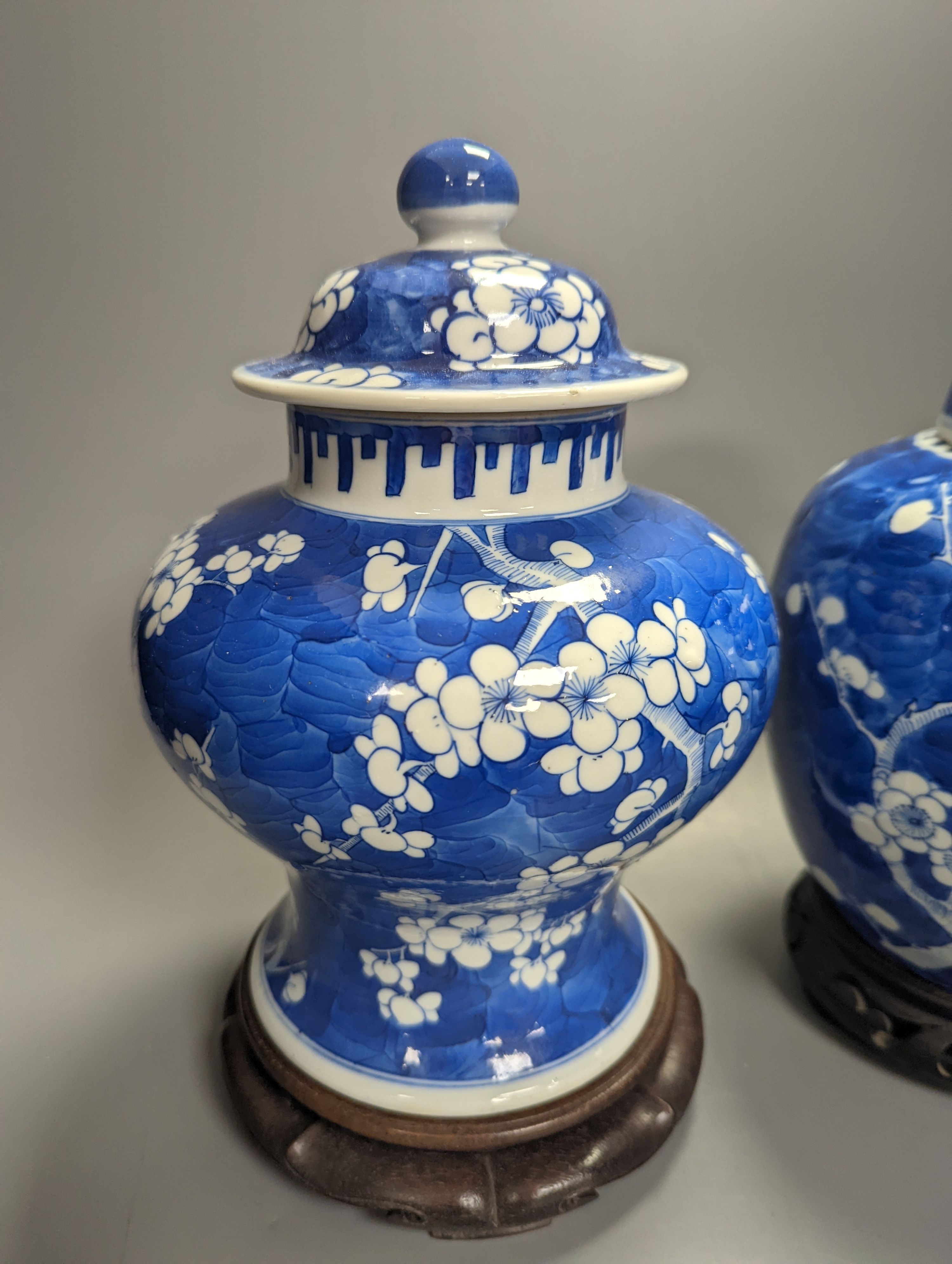 An 18th century Chinese blue and white prunus baluster jar and associated cover and a 19th century ginger jar, tallest 27cm incl. stand